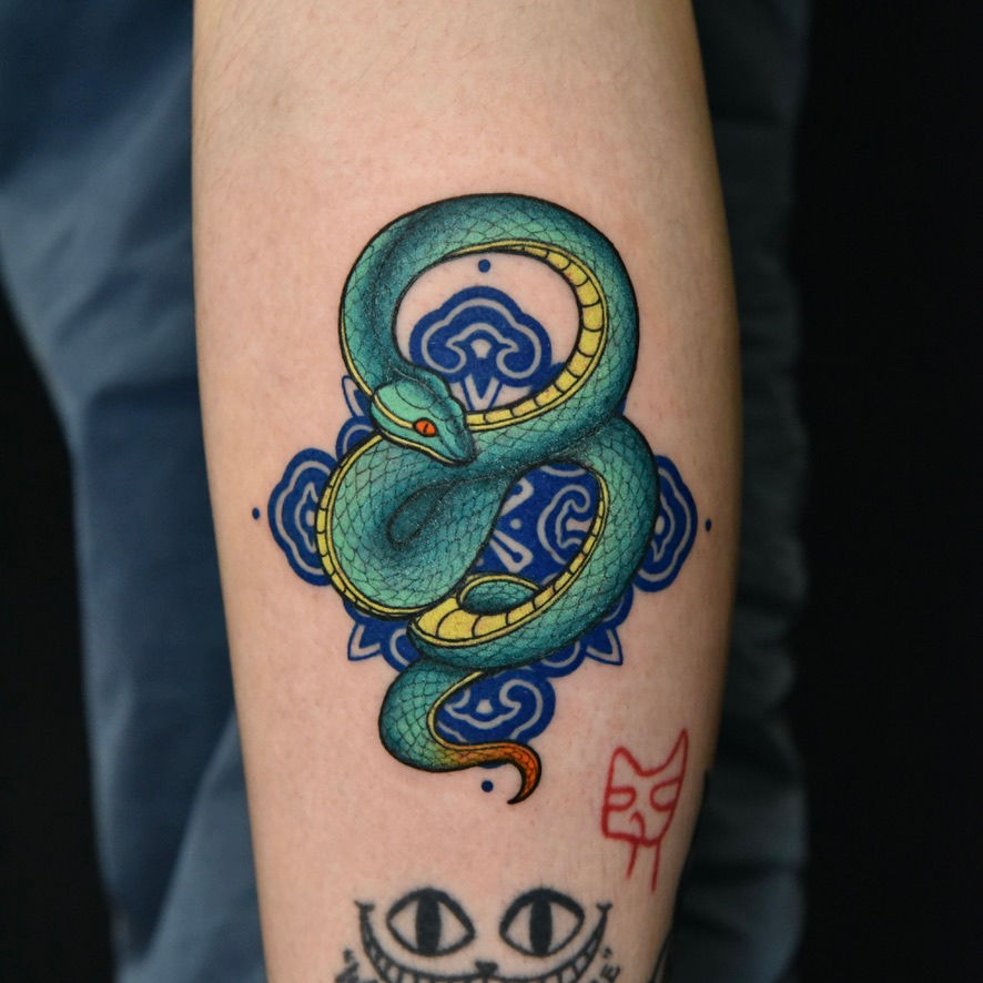 Asian-style serpent tattoo by Wild Crane Tattoos